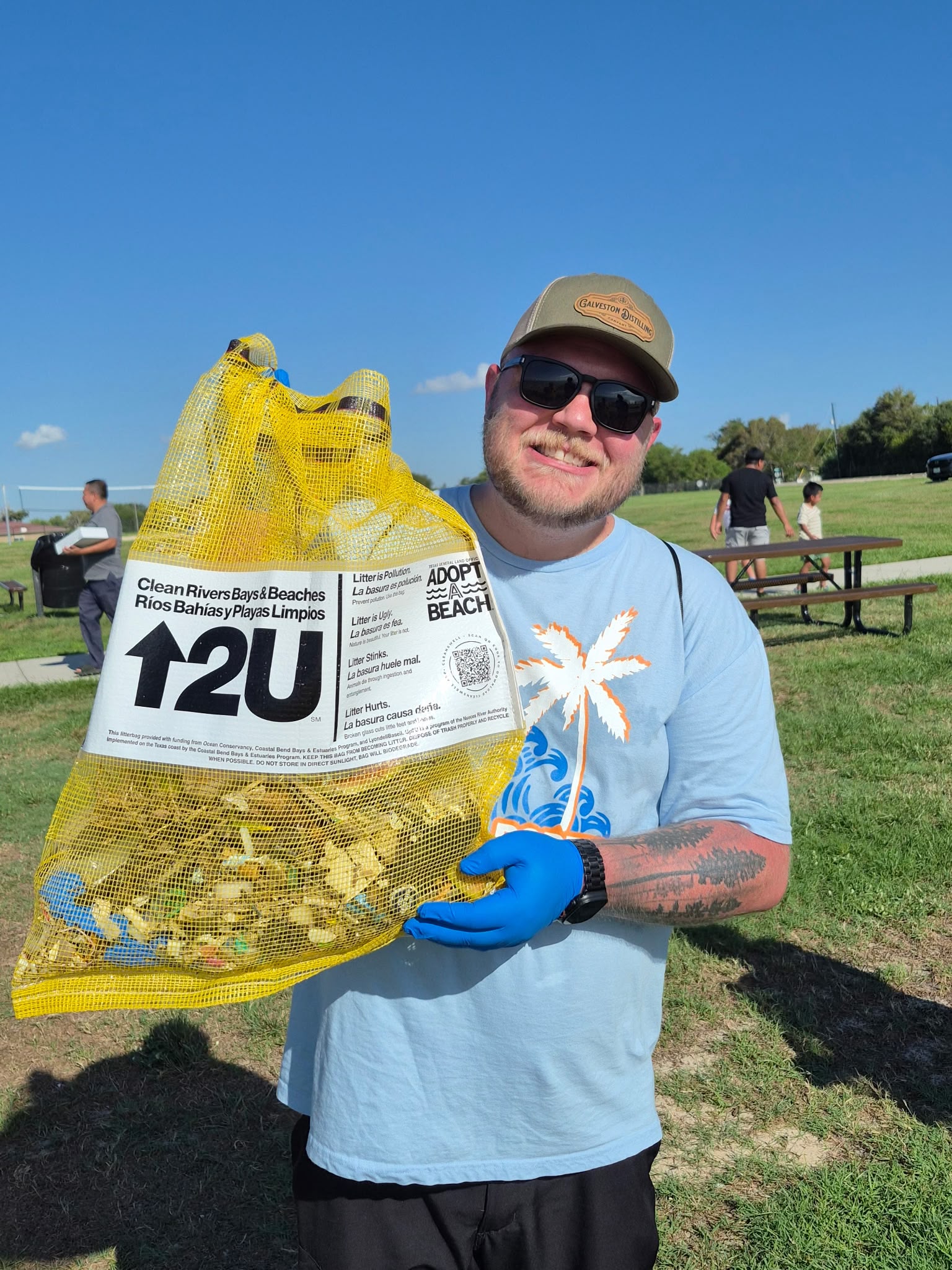Sylvan Beach Cleanup volunteer with trash bag